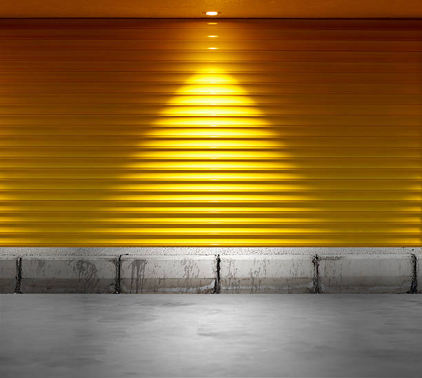 empty shop with metallic roller shutter yellow door empty shop with metallic roller shutter yellow door